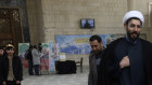 A cleric walks on the US and British flags while leaving a gathering to commemorate the late Iranian General Qassem Soleimani, who was killed in a US drone attack on January 3.
