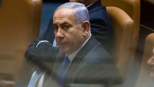 Outgoing Israeli Prime Minister Benjamin Netanyahu looks on after parliament voted to approve the new government and end his 12-year leadership.