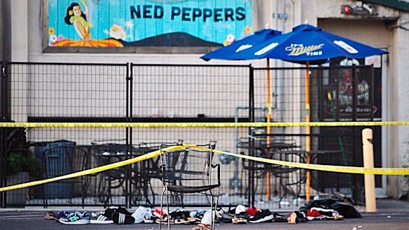 Police tape drapes over a chair near a pile of shoes after a mass shooting in Dayton, Ohio.