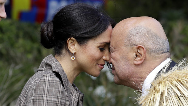 Meghan, the Duchess of Sussex, receives a "hongi" a traditional Maori welcome on the lawns of Government House in Wellington, New Zealand, 