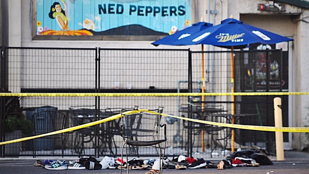 Police tape drapes over a chair near a pile of shoes after a mass shooting in Dayton, Ohio.