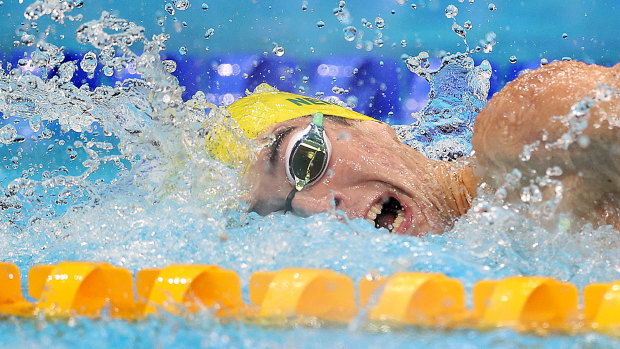 Tommy Neill powers through the water on his way to a relay bronze medal.