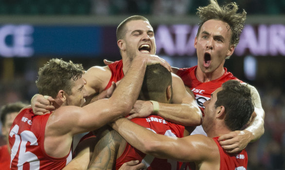 True grit:  The Swans celebrate a Lance Franklin goal against West Coast on Sunday.
