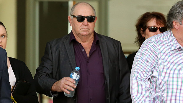 Edward Pye (centre) leaves the courthouse in Brisbane.