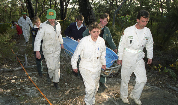 Rescue workers remove the body of a female British backpacker after it was discovered in the Belanglo State forest in 1992.
