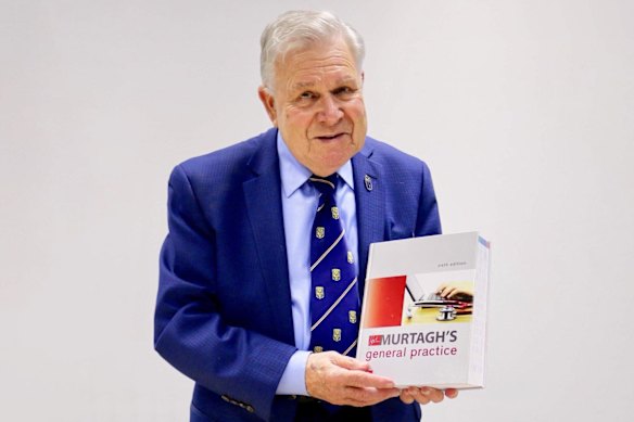 Professor John Murtagh with an edition of the textbook that made him globally famous, Murtagh’s General Practice.