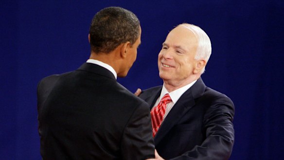 Barack Obama and John McCain greet each other at the start of a townhall-style presidential debate in 2008.