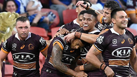 The Broncos mob try-scorer Jamayne Isaako, one of the few bright lights in an insipid match.