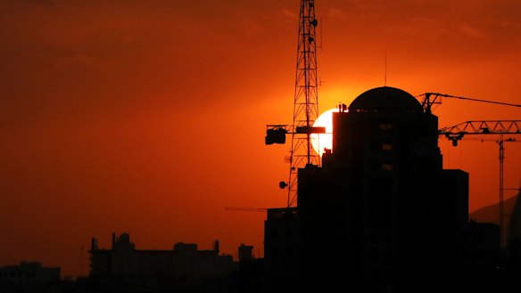 Buildings under construction are silhouetted against the setting sun in Tehran. Iran has threatened to increase its uranium enrichment above levels permitted by the 2015 accord.