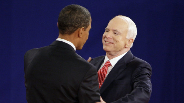 Barack Obama and John McCain greet each other at the start of a townhall-style presidential debate in 2008.