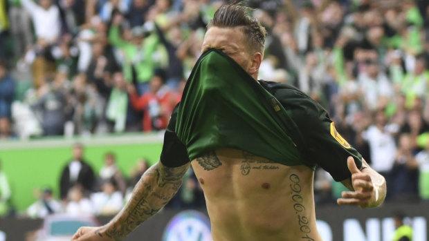 Joyous: Wolfsburg's Daniel Ginczek celebrates scoring the winner against Schalke.