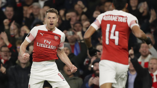 Arsenal's Aaron Ramsey (left) celebrates his team's first goal against Napoli in the Europa League.