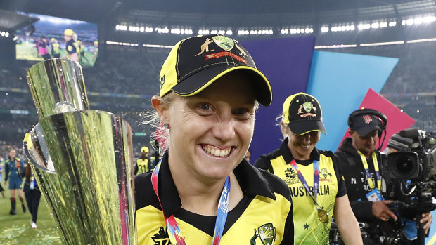 Alyssa Healy of Australia celebrates with the World Cup Trophy.