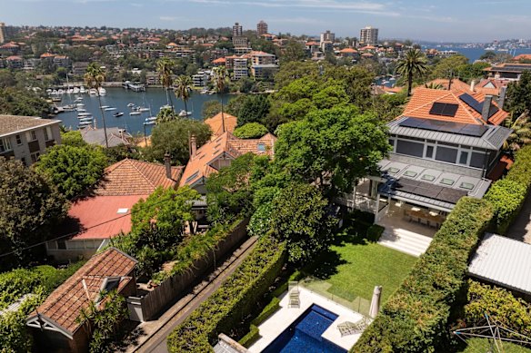 The property has an outdoor kitchen and level yard with a pool.