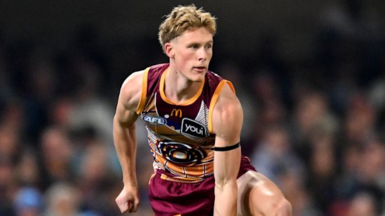 Jaspa Fletcher of the Lions handballs earlier this season.