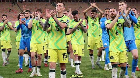 The Socceroos celebrate their win in Saudi Arabia.