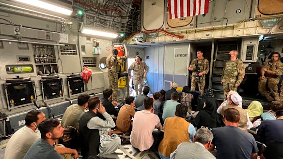 US Marine Corps General Frank McKenzie, the commander of US Central Command, enters a plane evacuating people, at Hamid Karzai International Airport, Afghanistan, on Tuesday.