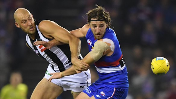 Clocking on: Big Ben Reid (left) replaced speedster Jaidyn Stephenson up forward for the Pies in round 14.