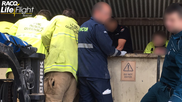 Queensland Fire and Emergency Services crews and paramedics worked together to free a man from a grain bin in an emu farm.