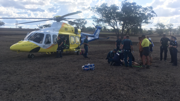 A man in his 20s was being airlifted to hospital after an excavator head had fallen and crushed him in a rural property outside of Toowoomba.