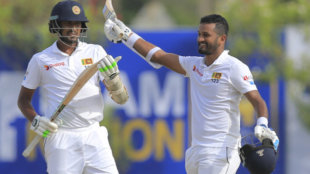 Sri Lanka\'s Dimuth Karunaratne, right, celebrates scoring a century.