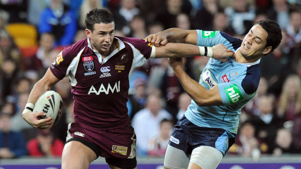 Darius Boyd tries to break free of a Jarryd Hayne tackle.