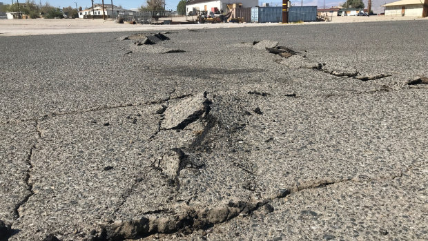 A road is damaged from an earthquake in Trona, California.