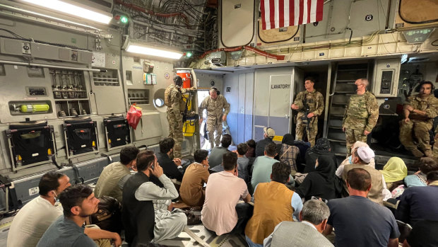 US Marine Corps General Frank McKenzie, the commander of US Central Command, enters a plane evacuating people, at Hamid Karzai International Airport, Afghanistan, on Tuesday.