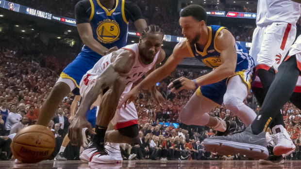 The Raptors' Kawhi Leonard goes head to head with Golden State's Stephen Curry in game five.