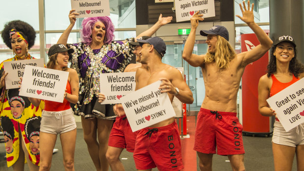 Lifeguards and drag queens greeted the flights from Victoria on Monday as the second-busiest route in the world for air travel resumed.  