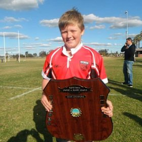 Billy Pollard with the NSW PSSA trophy after playing for the Sydney under 11s league team.