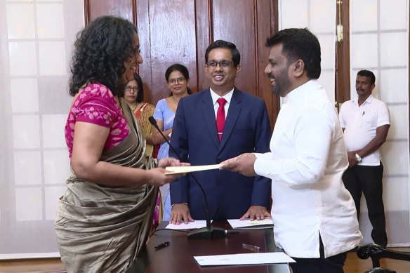 Harini Amarasuriya, 54, left, takes oath for the post of Sri Lanka’s Prime Minister in front of President Anura Kumara Dissanayake, right, in Colombo, Sri Lanka.