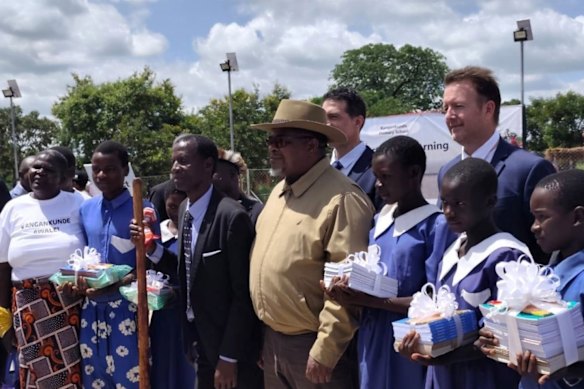 Lindian Resources executive chairman Robert Martin, executive director Zac Komur and the Hon. Bright Msaka SC with students of the Kangankunde Primary School and members of the local community.