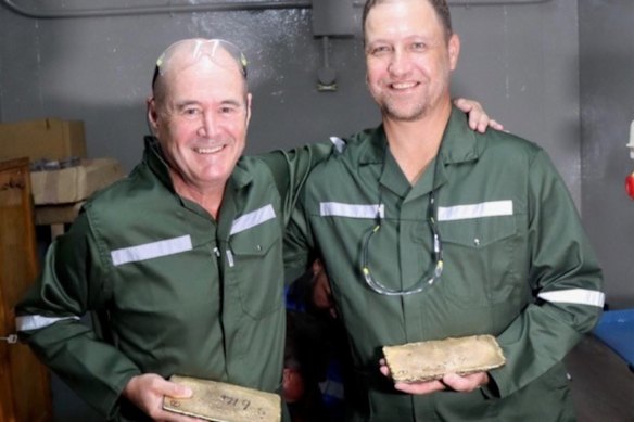 West Wits Mining chairman Michael Quinert (left) and CEO Rudi Deysel hold the first gold bars poured from the company’s South African Qala Shallows mine on 17 March.