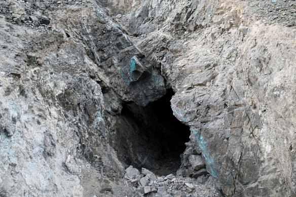 

Flagship Minerals Rosario copper project, where old workings exhibit characteristic blue-green copper oxide staining on joint planes.