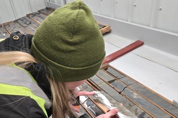 Olympio Metals geologist examining diamond drill core from the company’s Bousquet project in Quebec.