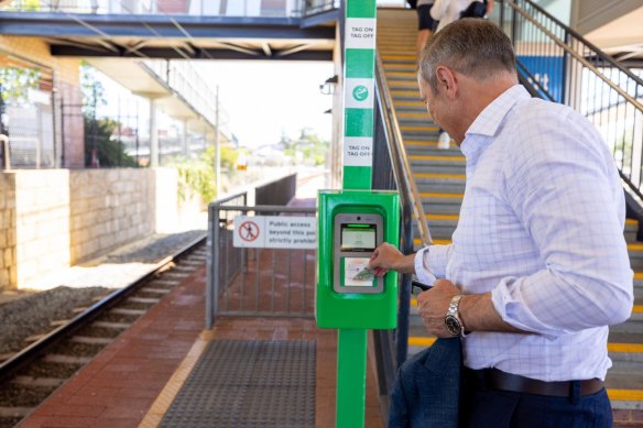 Premier Roger Cook taps his SmartRider.
