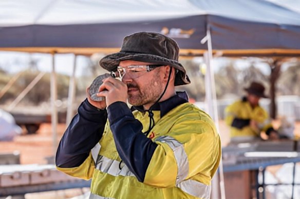 A Gateway Mining geologist examining a rock sample. Reinterpretation and recent drilling have led to the definition of a 7km-long gold mineralised zone within the Celia Shear zone, part of the company’s Yandal gold project in WA.