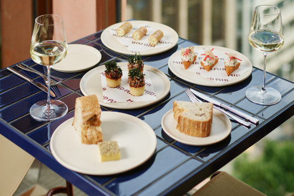 Swing by Mid Air rooftop for tiny snacks and big city views.