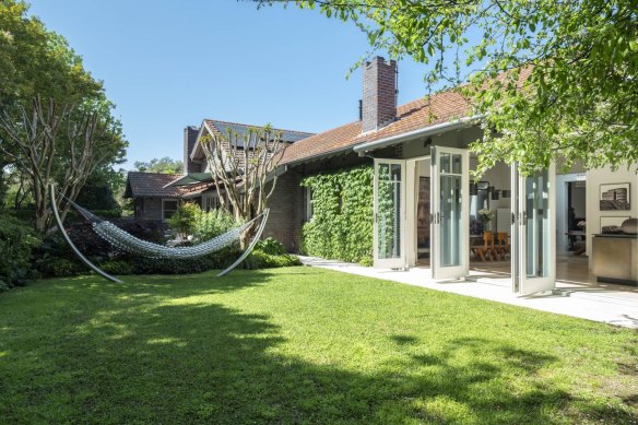 The Braelin garden features a glass hammock on the back lawn by artist Pinaree Sanpitak.