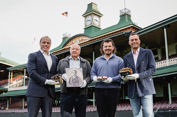 RA chief executive Phil Waugh, Jim Menck, Ned Fryar and Paul Menck pose with Tom Richards’ photo, Olympic gold medal, Military Cross and his Wallabies and Lions Test caps.