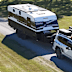An SUV towing a caravan made by Essential Caravans.