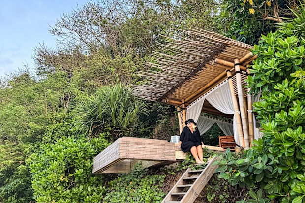 A woman sitting in a beachside cabana