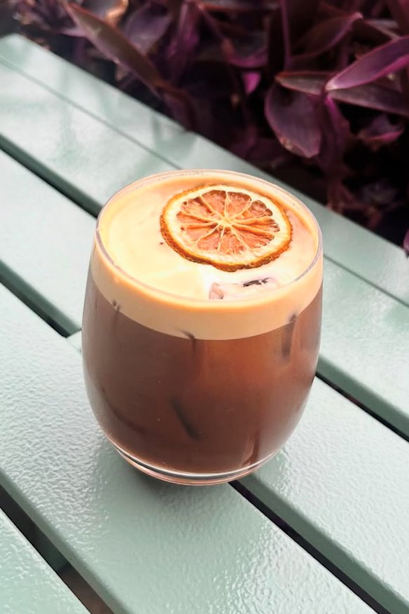 The orange aerocano drink featuring iced coffee with orange soda.