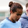 Mary Fowler leaves the field with a Man City trainer.
