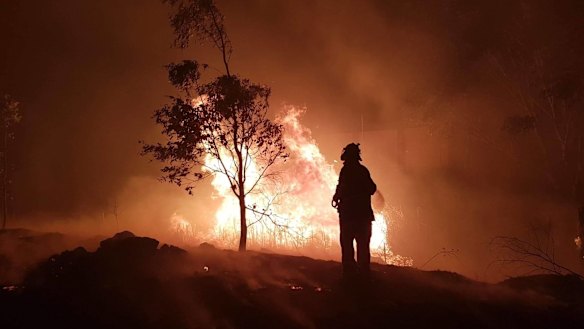A firefighter douses the flames in Stanthorpe.