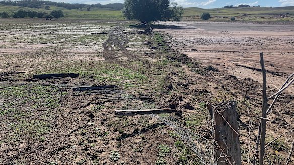 The damage to Mr Orr's fences and paddocks from the rain.