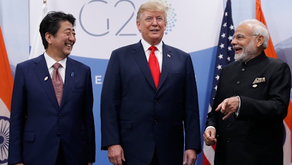 US President Donald Trump  with India's Prime Minister Narendra Modi, right, and Japan's Prime Minister Shinzo Abe, on Friday.
