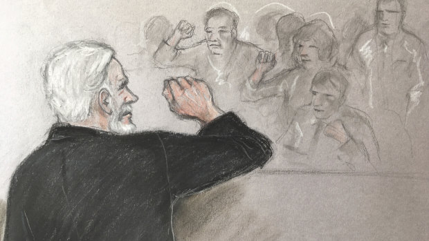 Court artist sketch depicting Julian Assange, left, saluting his supporters as he appears at Southwark Crown Court in London.