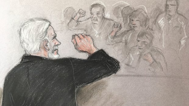 Court artist sketch depicting Julian Assange, left, saluting his supporters as he appears at Southwark Crown Court in London.